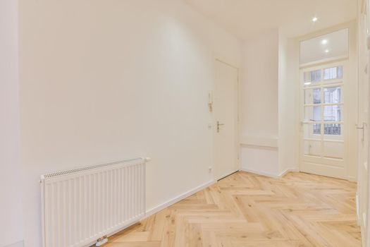 Modern room with wooden floor and white walls