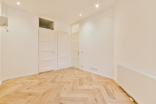 Modern room with wooden floor and white walls