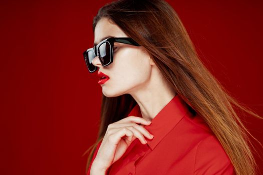 glamorous woman wearing sunglasses red shirt hairstyle model. High quality photo
