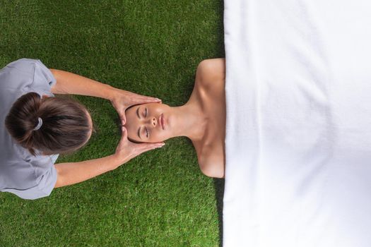 Woman at spa face massage procedures to clean the skin. top view shot.