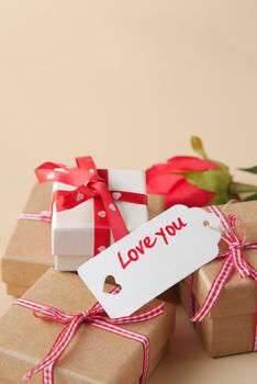 Top view of gift box, envelope and rose flower on white background .