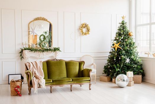 Merry Christmas and Happy New Year. beautiful cozy living room decorated for Christmas with green couch and christmas tree