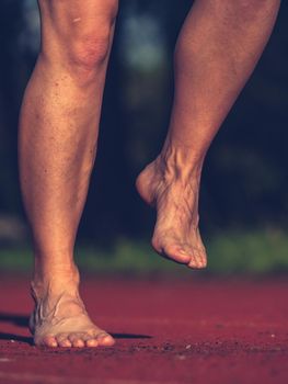 Naked tired legs of working woman saved time for evening fitness run. Real peeople do real sport