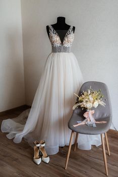 bridesmaid dress on a mannequin with a bouquet and shoes