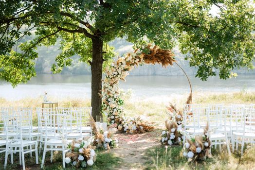 wedding ceremony area with dried flowers in a meadow in a green forest