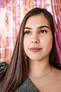 New Year party celebration.Closeup of woman in glitter dress standing on glitter purple and gold background