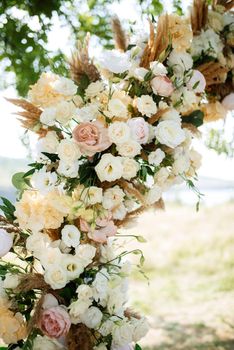 wedding ceremony area with dried flowers in a meadow in a green forest