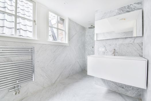 An elegant bathroom interior with big mirror