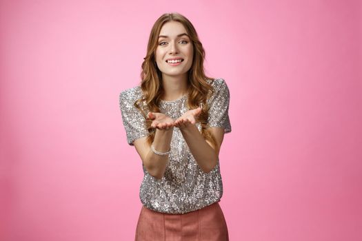 Girl suggesting you heart. Portrait lovely romantic european woman expressing sympathy extending hands presenting love, show admiration passion desire start relationship, standing pink background.