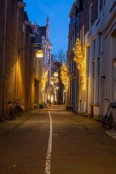 Old street in the city center from Deventer in the Netherlands at sunset in christmas time