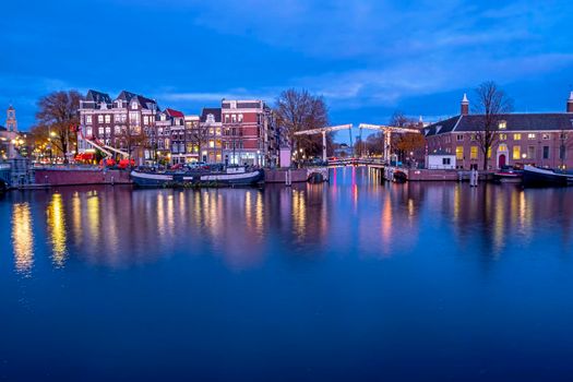 City scenic from Amsterdam at the river Amstel in the Netherlands at sunset