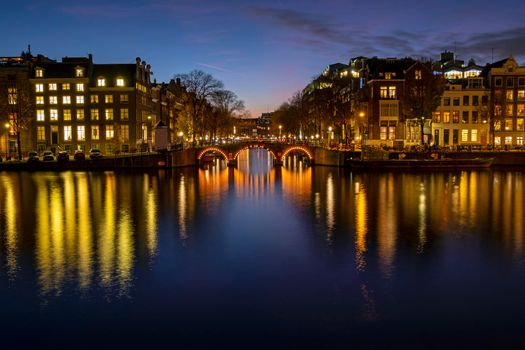 City scenic from Amsterdam at the river Amstel in the Netherlands at sunset