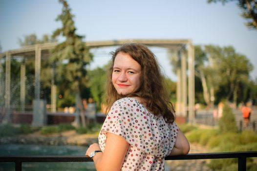 Young girl in dress is having great time during vacation in the summer on sky background in nature, travelling concept.