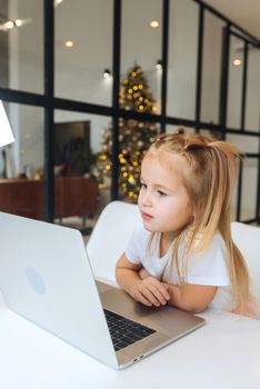 Happy little girl using tablet computer