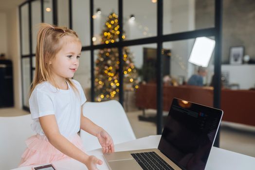 Happy little girl using tablet computer