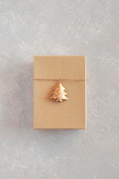 craft paper gift box decorated with golden metal New Year tree