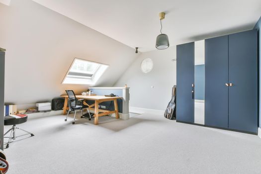 Attic studio room in white and blue colors