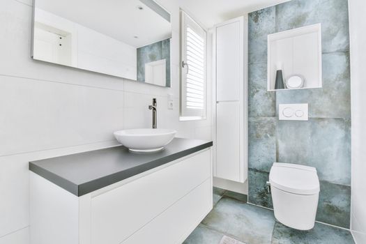 Stylish bathroom with large marble tiles on the walls and floor