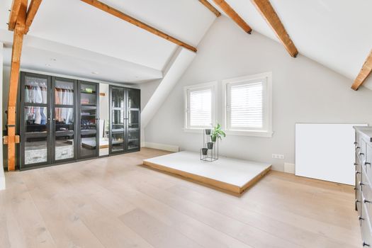 A bright room with a full-length black wardrobe