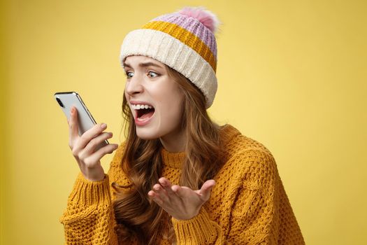 Annoyed pissed freak-out crazy woman shouting smartphone look display near face irritated arguing boyfriend breaking-up via phone call standing angry furiously yelling cellphone, raise hand dismay.