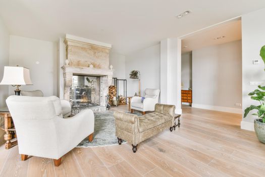 Luxurious living room with soft sofa and armchairs