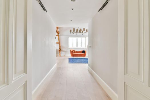 Long stunning hallway with wood flooring and white walls