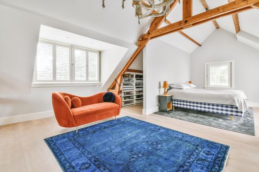 Cozy bright room with a bright red sofa in the middle