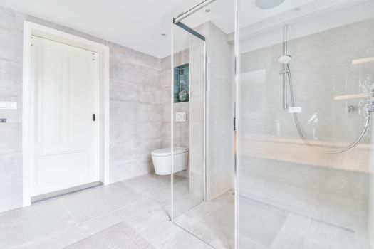 Stylish bathroom with large marble tiles on the walls and floor