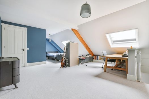 Attic studio room in white and blue colors