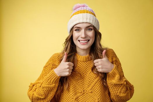 Close-up charming supportive kind young woman show thumbs-up gesture smiling approval liking your idea encourage keep up, satisfied good excellent choice, standing pleased yellow background.