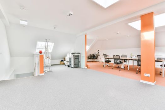 Large room with two pillars and a large archway leading to the work area