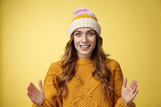 Amazed excited attractive young 20s girl describing large awesome product show big box shape smiling astonished standing thrilled impressed incredible merch, standing yellow background.