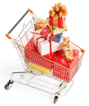 Shopping Cart is Full of Christmas Gift Boxes of Different Sizes, Colors and Shapes. Big Pile of Christmas Gifts in the Shopping Cart. Close-up. White Background. High quality photo