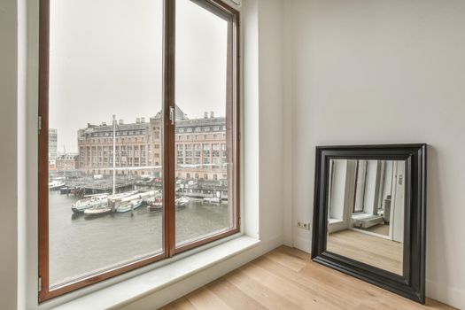 Modern room with wooden floor and white walls