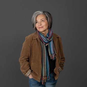 Pretty mid aged grey haired woman in casual portrait. Happy business woman smiling. Human emotions, facial expression concept. Different facial expressions, emotions, feelings.
