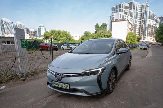 Front view Chinese Electric vehicle Buick VeLite 6 on streets of Kyiv, near EV charging station. General Motors family next generation electric car based on Chevrolet Bolt technology . 17th of june 2021 Kyiv, Ukraine,. High quality photo