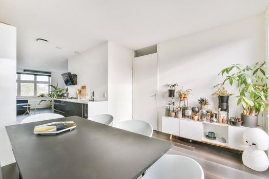 Attractive dining room with many flowers in the background