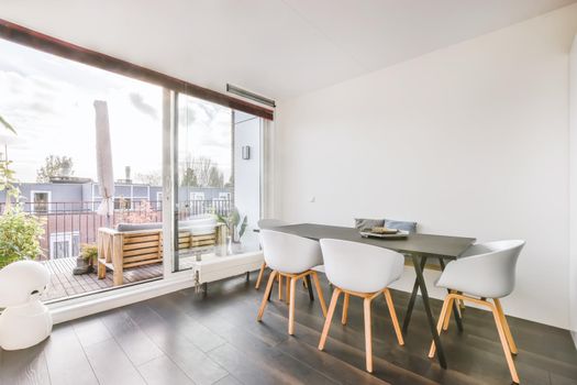 Attractive dining room with large wall-to-ceiling window
