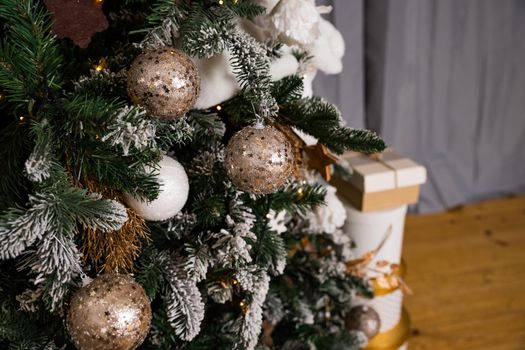 beautiful big Christmas tree decorated with balls and toys holiday christmas mood gifts with ribbons.