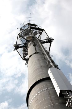 High telecommunication tower on blue sky background - Photo