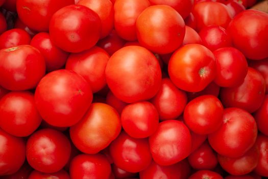 Ripe tomatoes flaunt on the counter of a grocery store. High quality photo