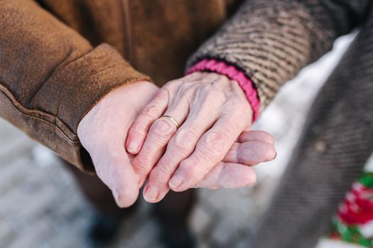 Close up hands of seniors people. Male and female. Couple. Grandpa and grandma. Love forever.