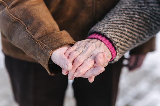 Close up hands of seniors people. Male and female. Couple. Grandpa and grandma. Love forever.