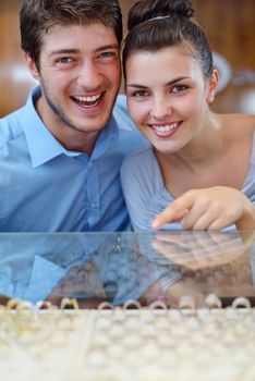 happy young romantic couple in love buy jewelry ring in luxury store