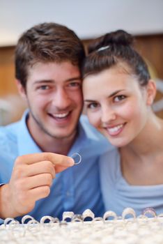 happy young romantic couple in love buy jewelry ring in luxury store