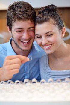 happy young romantic couple in love buy jewelry ring in luxury store