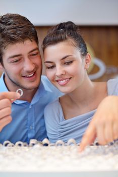 happy young romantic couple in love buy jewelry ring in luxury store