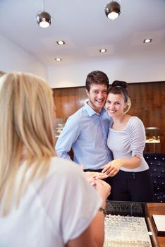 happy young romantic couple in love buy jewelry ring in luxury store