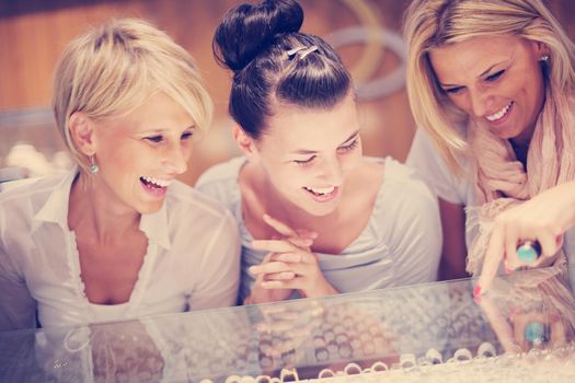 happy girls group  have fun while shopping in jewelry store