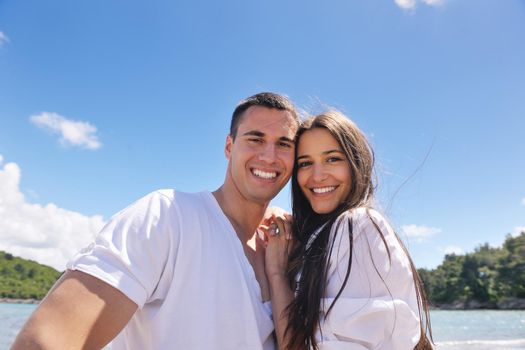 happy young couple have fun and relax  on the beach